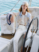a lady in long sleeve shirt with white pants